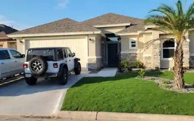 Two vehicles parked in front of the garage